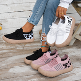 Bootara Cerynna Pink Black White sneakers together with Black worn on feet