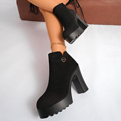 Veylisse Black platform ankle boots worn on foot, angled view