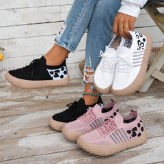 Bootara Cerynna Pink Black White sneakers together with Black worn on feet