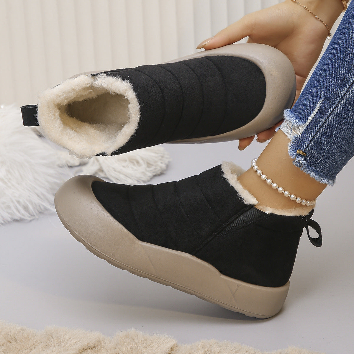 Sorielle Black winter ankle boots worn on foot and showing plush lining
