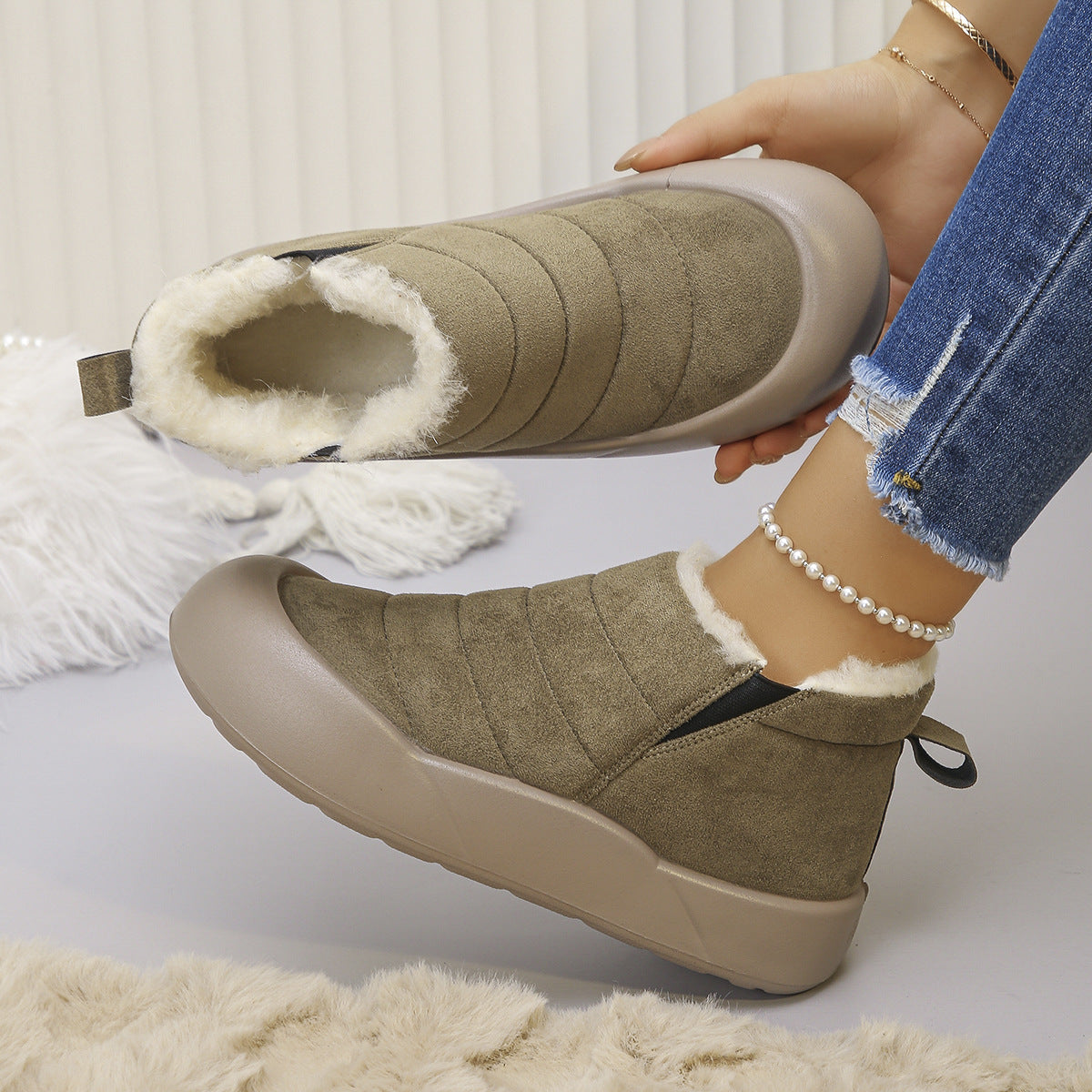 Sorielle Green winter ankle boots worn on foot and showing plush lining