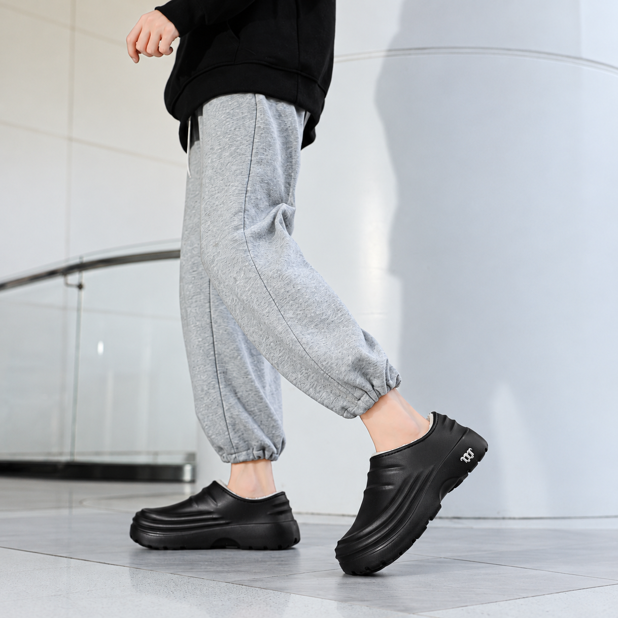 Rovelle Black plush lined slip-on clogs worn on foot, view 1