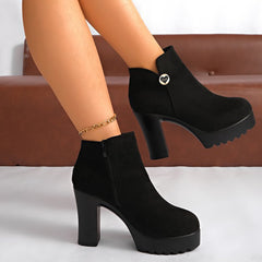 Veylisse Black platform ankle boots worn on foot, showing block heels and heart detail