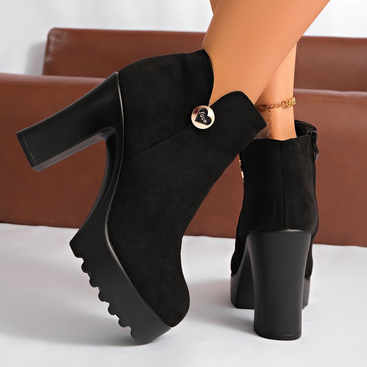 Veylisse Black ankle boots worn on foot, rear view showing zipper and block heel